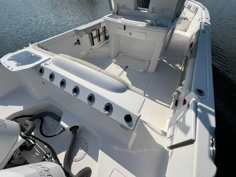 Slide: The Image of 2013 Everglades 295 Center Console boat interior with fishing rod holders. - 13