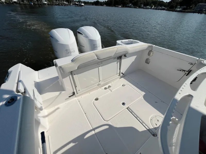 Slide: The Image of 2013 Everglades 295 Center Console boat with dual engines on calm water. - 14