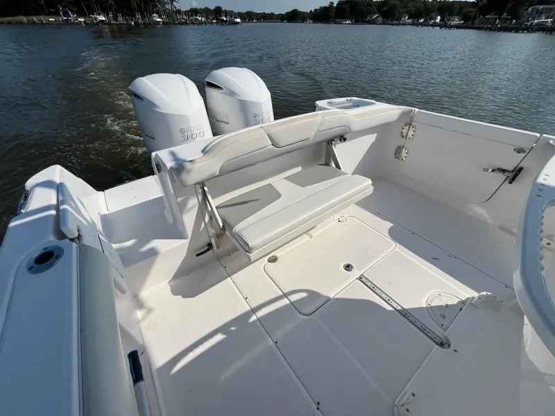 Slide: The Image of 2013 Everglades 295 Center Console boat with dual engines on a calm lake. - 15