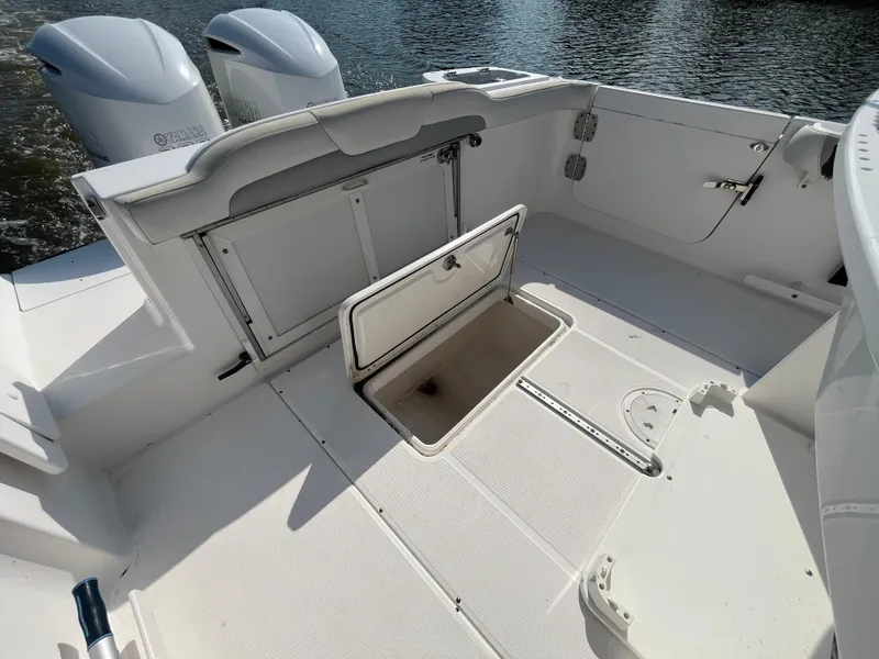 Slide: The Image of 2013 Everglades 295 Center Console boat interior with open storage compartment. - 16