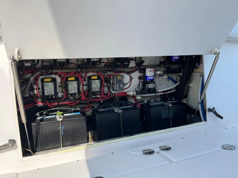 Slide: The Image of 2013 Everglades 295 Center Console battery compartment with wiring and components. - 17