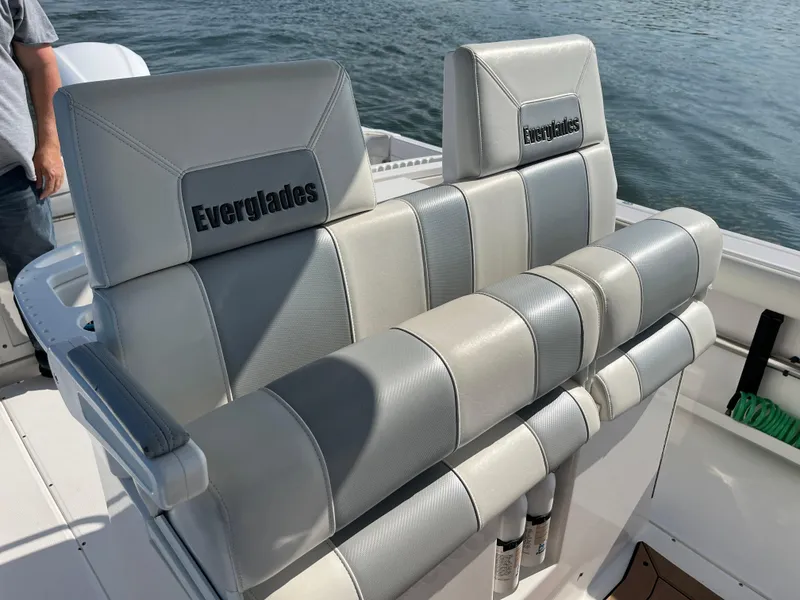 Slide: The Image of 2013 Everglades 295 Center Console boat seats with logo, on calm water. - 21
