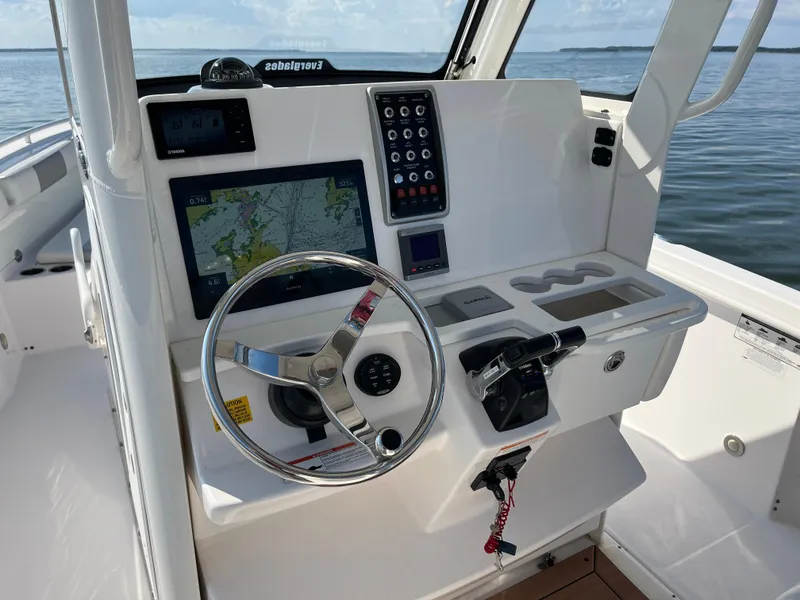 Slide: The Image of 2013 Everglades 295 Center Console boat dashboard with navigation system and controls. - 23