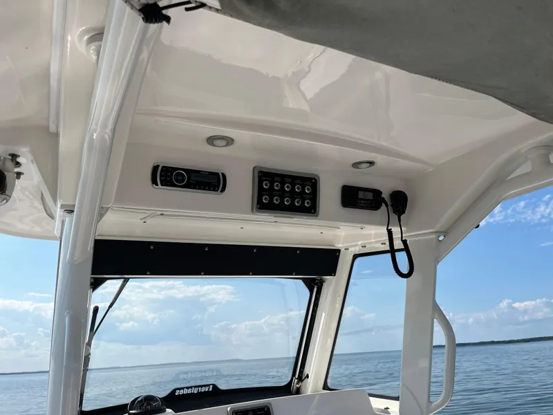 Slide: The Image of Interior view of 2013 Everglades 295 Center Console boat with control panel and ocean backdrop. - 24