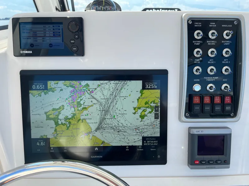 Slide: The Image of Dashboard of 2013 Everglades 295 Center Console with navigation and control panels. - 25