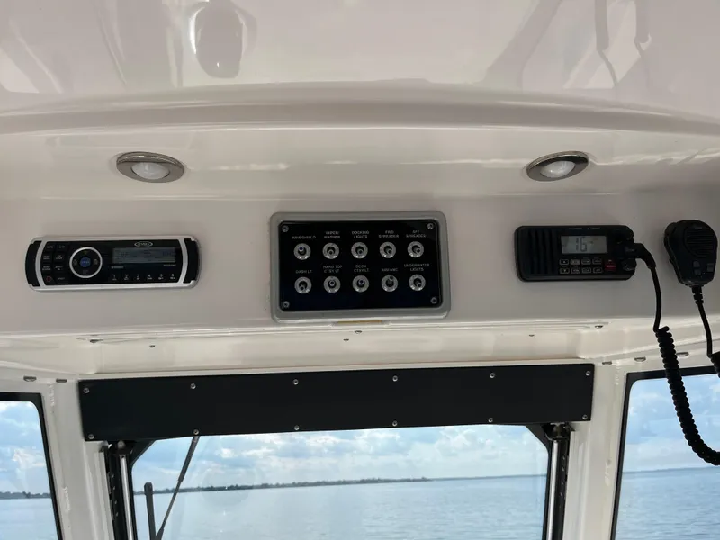Slide: The Image of 2013 Everglades 295 Center Console dashboard with radio and control panel. - 27