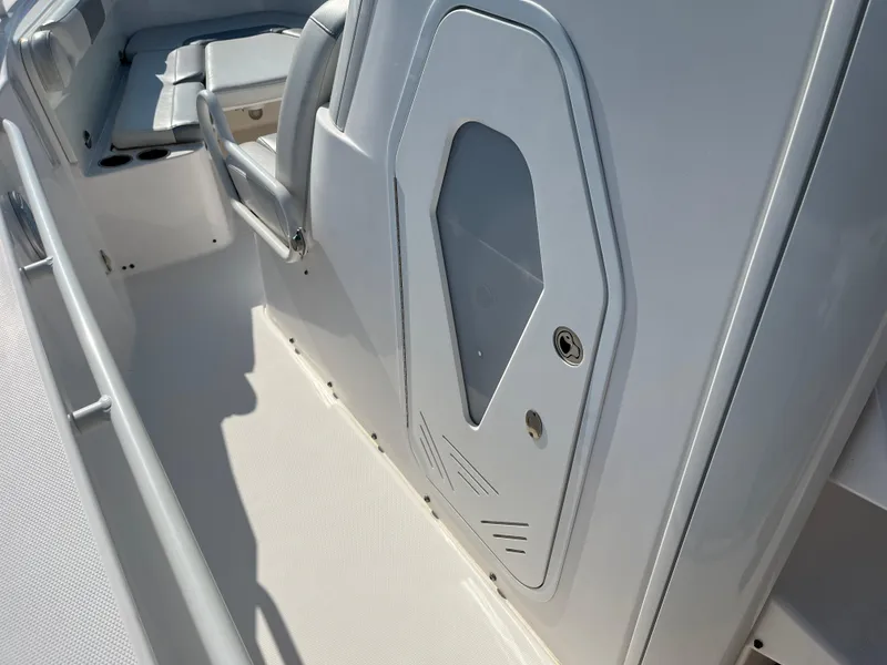 Slide: The Image of 2013 Everglades 295 Center Console boat interior with seating and storage compartment. - 29