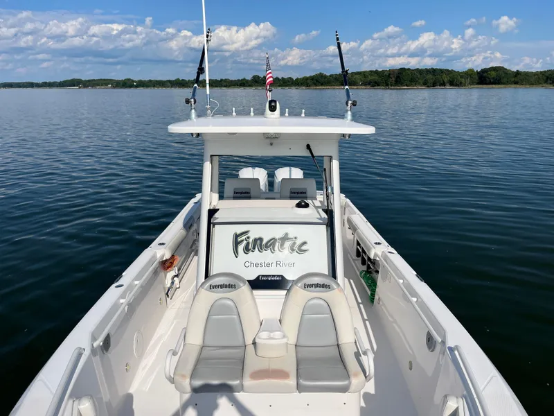 Slide: The Image of 2013 Everglades 295 Center Console boat on calm water, clear sky background. - 34