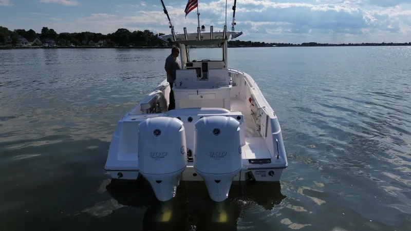 Slide: The Image of 2013 Everglades 295 Center Console boat on calm water with dual engines. - 4