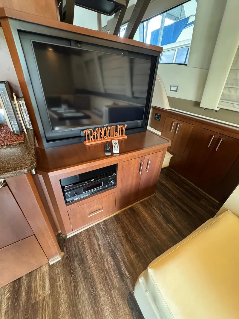 Slide: The Image of Interior of 2013 Carver 54 Voyager yacht with TV and wooden cabinetry. - 14