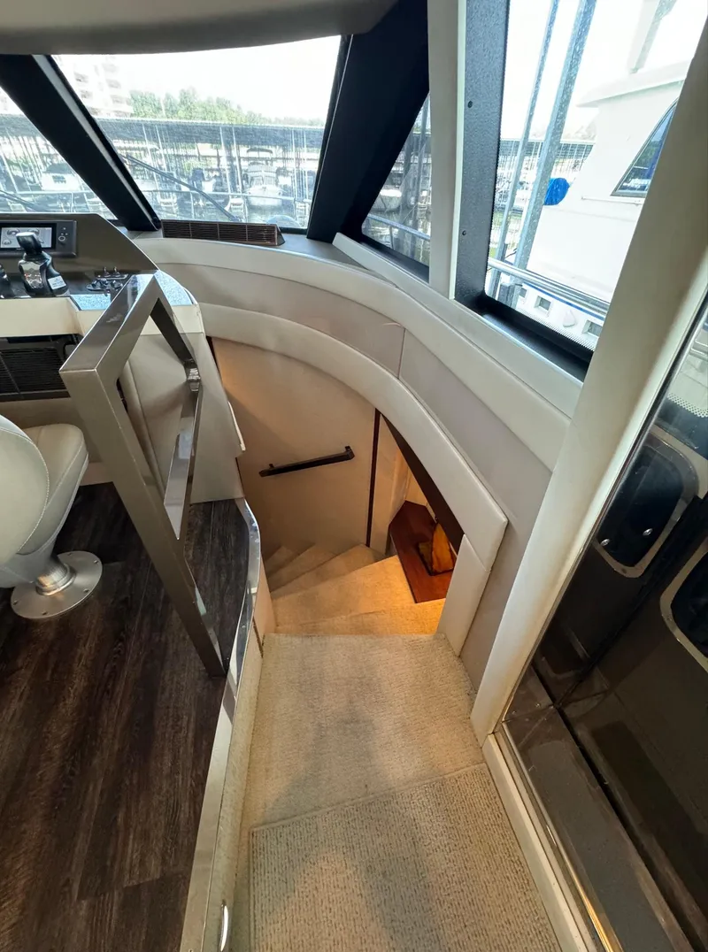 Slide: The Image of Interior view of 2013 Carver 54 Voyager yacht, featuring a staircase and helm area. - 15