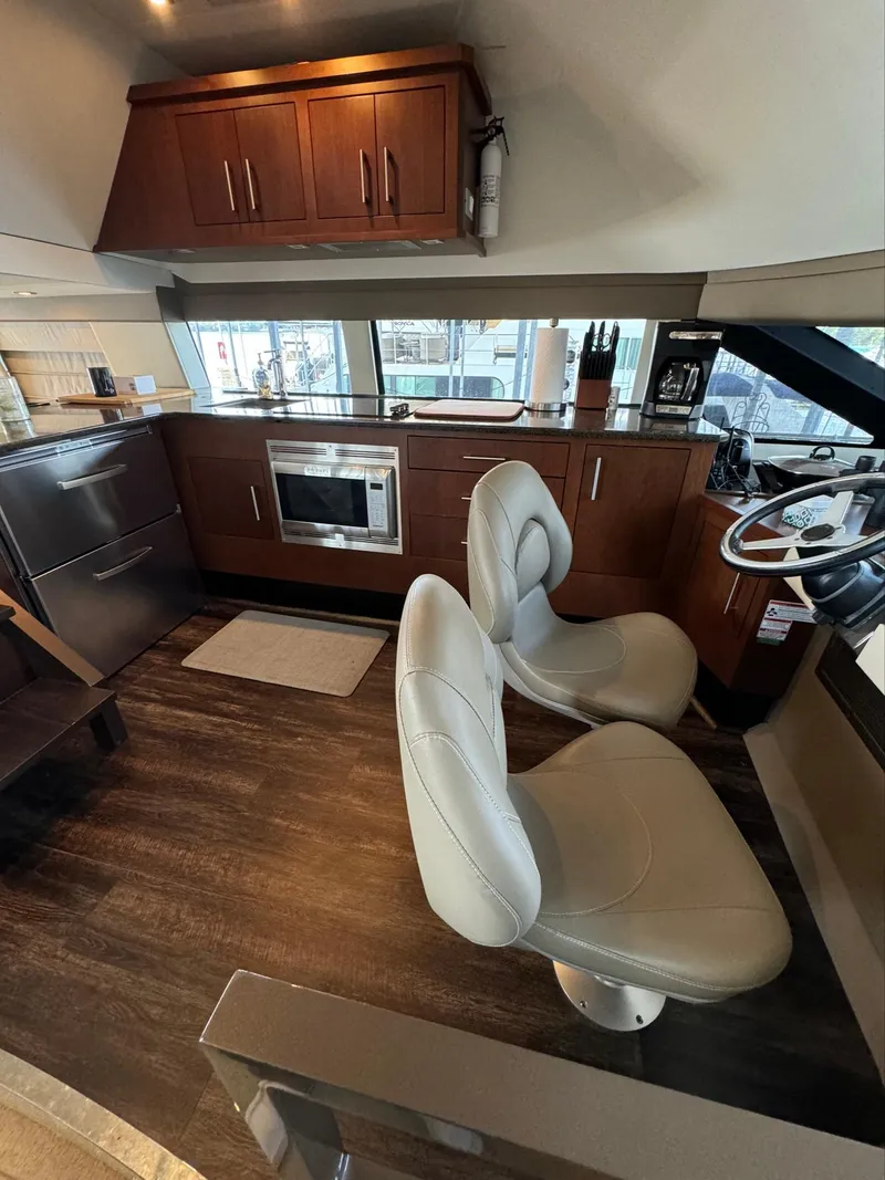 Slide: The Image of Interior of 2013 Carver 54 Voyager yacht with modern kitchen and seating area. - 16