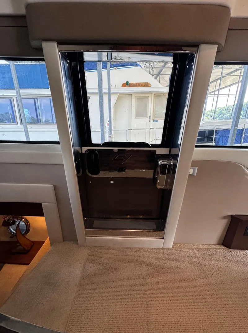 Slide: The Image of Interior view of 2013 Carver 54 Voyager yacht with carpeted flooring and glass door. - 19