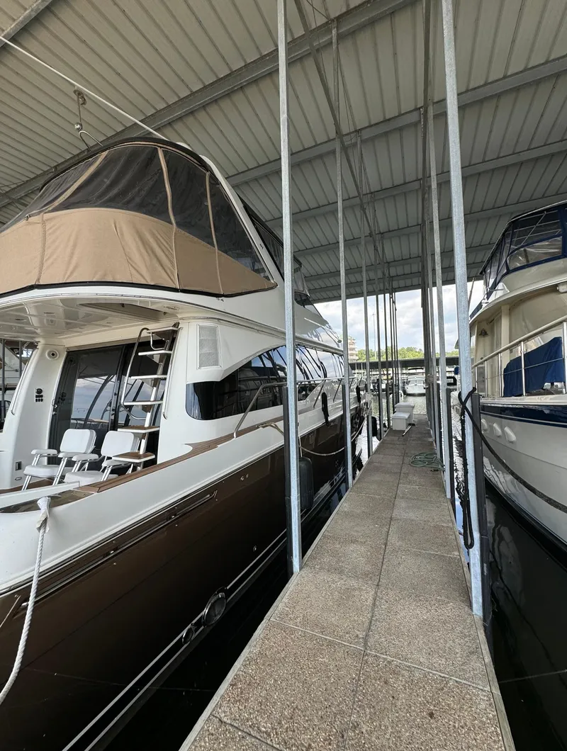 Slide: The Image of 2013 Carver 54 Voyager yacht docked in a covered marina. - 2