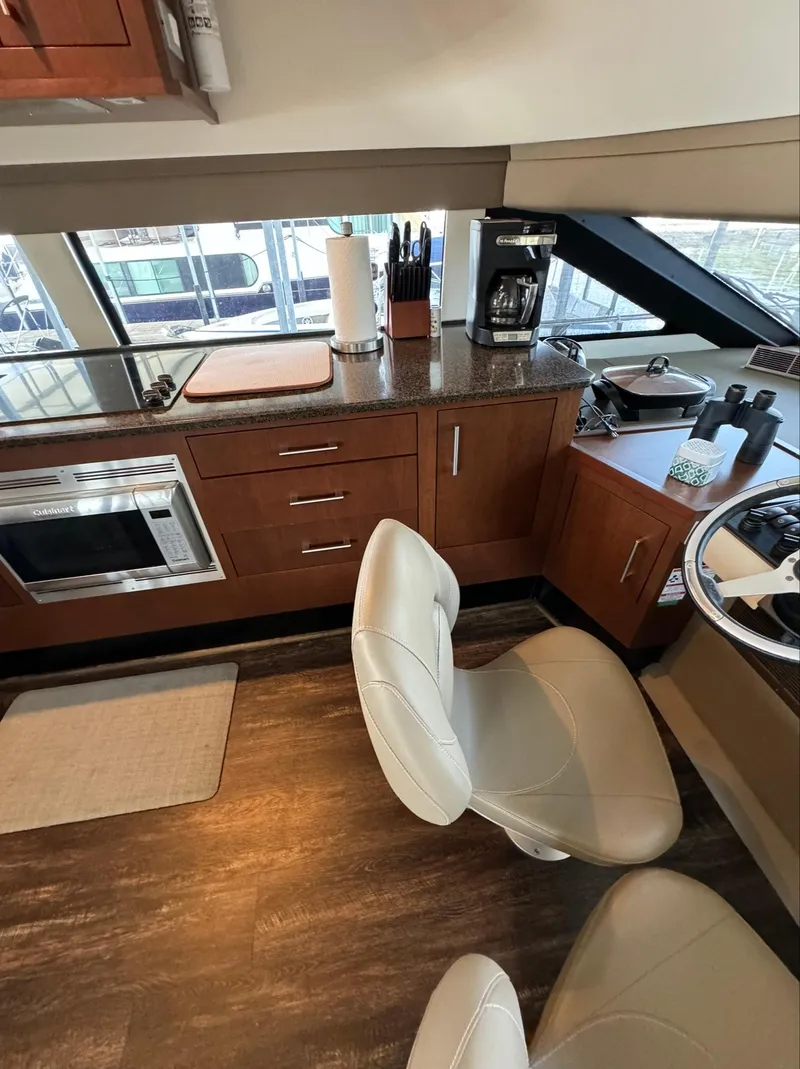 Slide: The Image of Interior of 2013 Carver 54 Voyager yacht with modern kitchen and seating area. - 22
