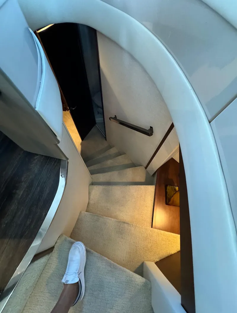 Slide: The Image of Interior staircase of 2013 Carver 54 Voyager yacht, featuring carpeted steps and modern design. - 24