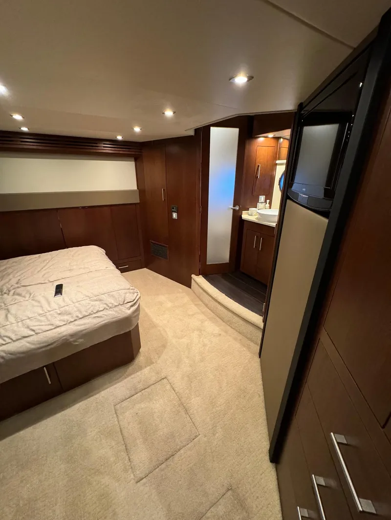 Slide: The Image of Interior of 2013 Carver 54 Voyager yacht with cozy bedroom and ensuite bathroom. - 25