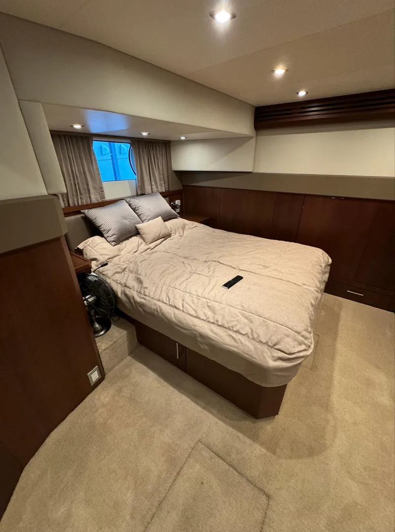 Slide: The Image of Luxurious bedroom interior of 2013 Carver 54 Voyager yacht with cozy bedding. - 26