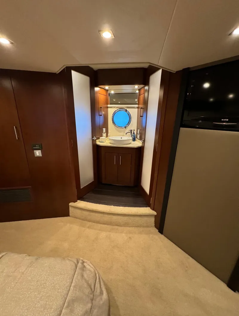 Slide: The Image of Interior of 2013 Carver 54 Voyager yacht with elegant wood finish and compact bathroom. - 27