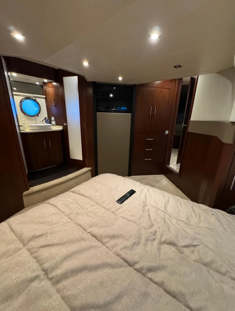 Slide: The Image of Interior of 2013 Carver 54 Voyager yacht with luxurious bedroom and modern amenities. - 28