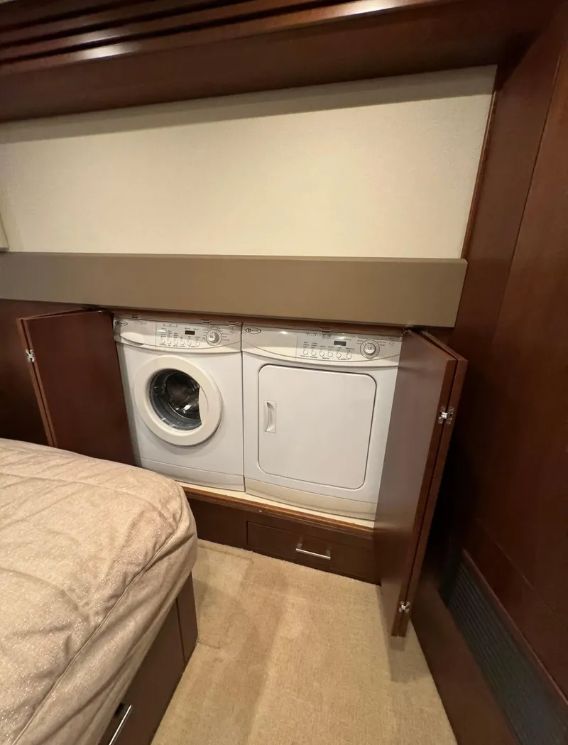 Slide: The Image of Laundry area inside 2013 Carver 54 Voyager yacht with washer and dryer. - 29