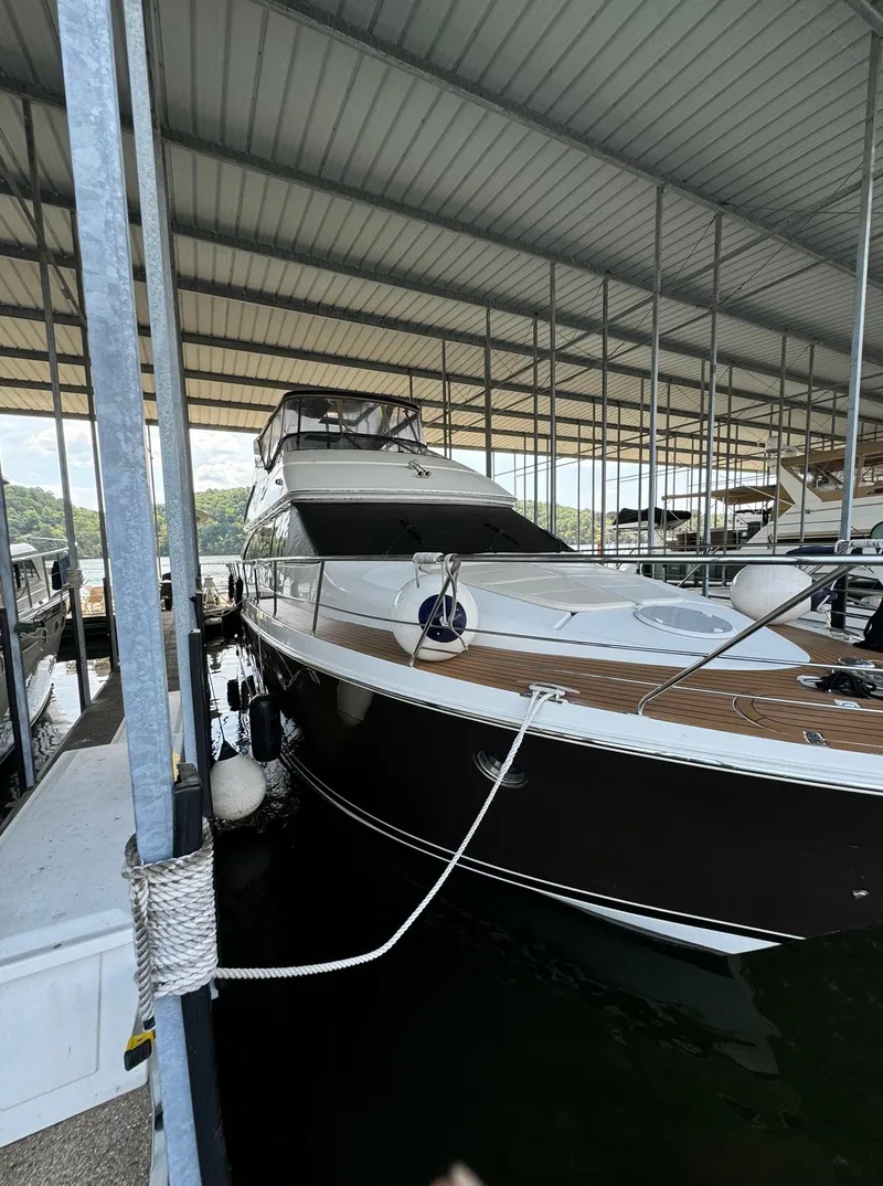 Slide: The Image of 2013 Carver 54 Voyager yacht docked under a covered marina. - 3