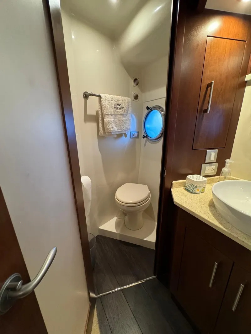 Slide: The Image of 2013 Carver 54 Voyager yacht bathroom with modern fixtures and porthole window. - 30