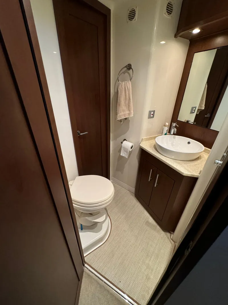 Slide: The Image of 2013 Carver 54 Voyager bathroom with modern fixtures, sink, and toilet. - 32