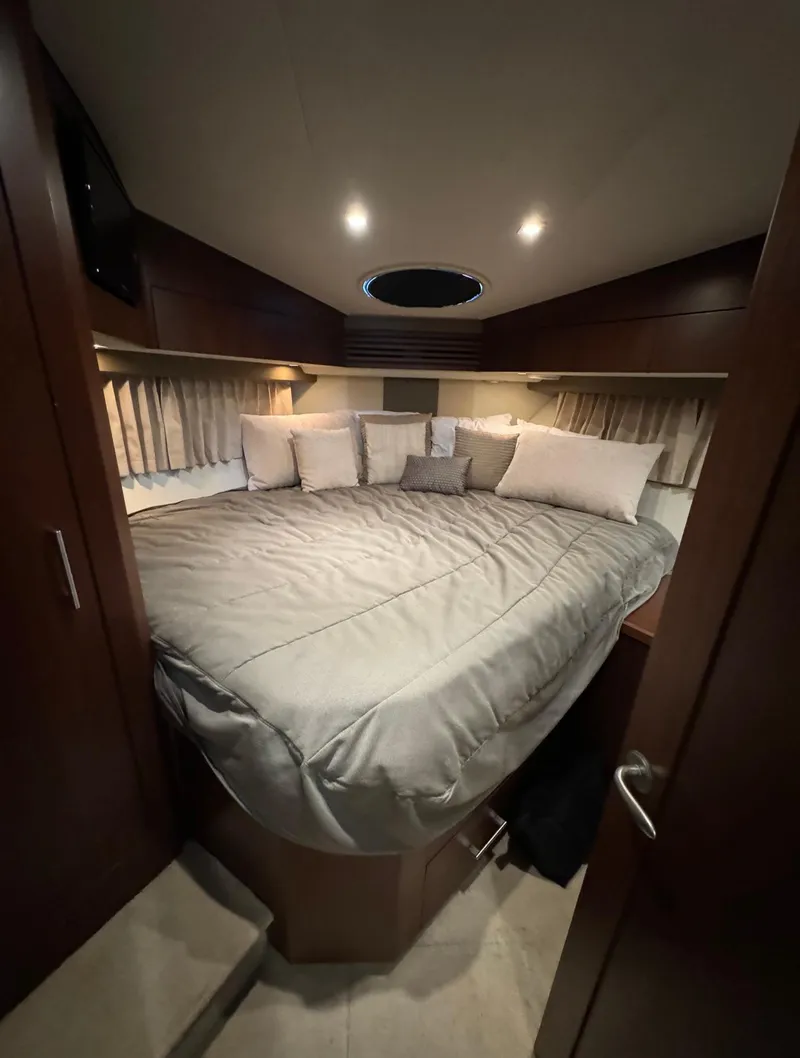 Slide: The Image of Luxurious bedroom interior of 2013 Carver 54 Voyager yacht with cozy bedding and ambient lighting. - 34