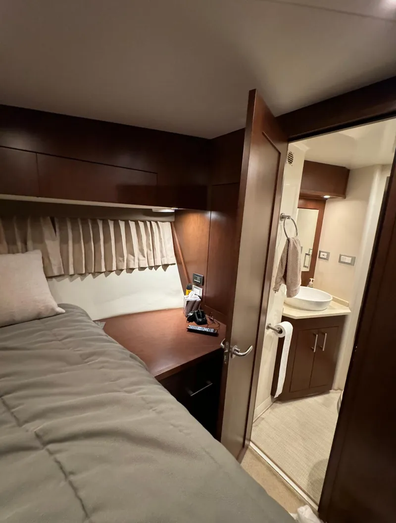 Slide: The Image of Interior of 2013 Carver 54 Voyager yacht, featuring a cozy bedroom and modern bathroom. - 35