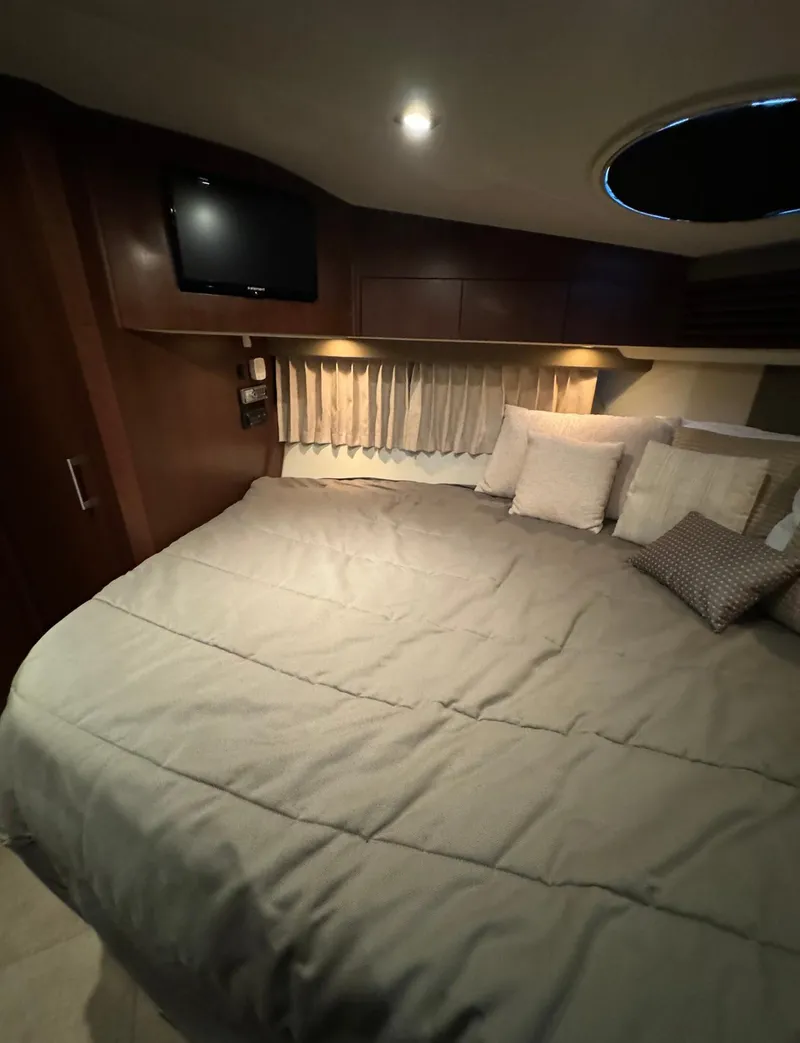 Slide: The Image of Luxurious bedroom interior of 2013 Carver 54 Voyager yacht with cozy bedding and ambient lighting. - 36
