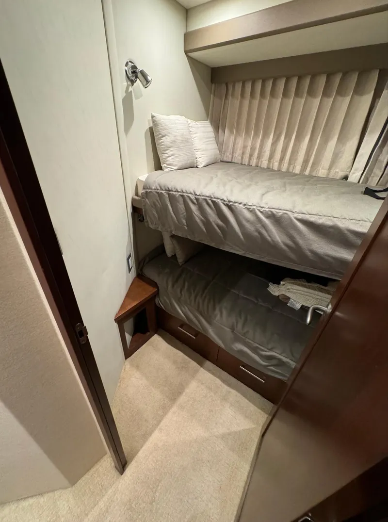 Slide: The Image of 2013 Carver 54 Voyager cabin with bunk beds and modern decor. - 37