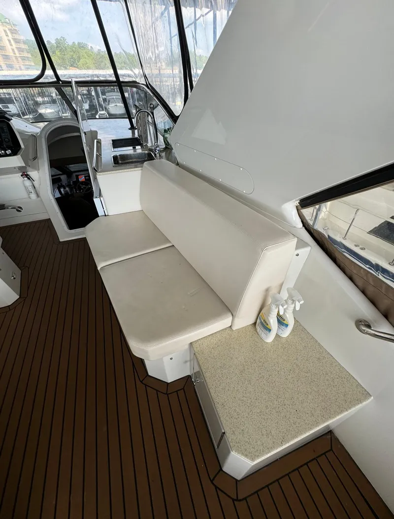 Slide: The Image of 2013 Carver 54 Voyager interior with white seating and wooden flooring. - 38