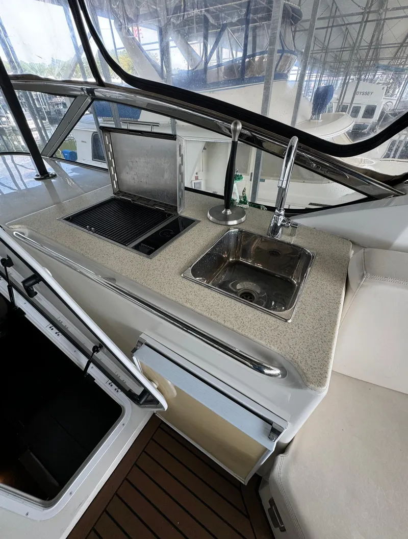 Slide: The Image of 2013 Carver 54 Voyager yacht kitchen area with sink and grill. - 39