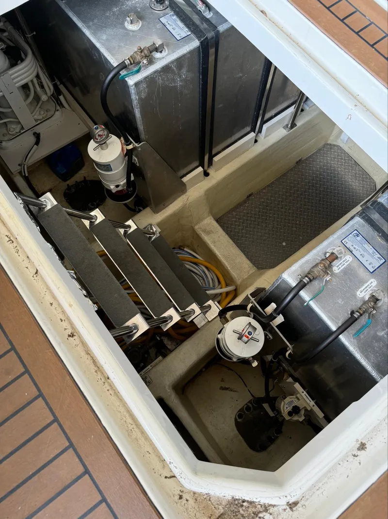 Slide: The Image of Engine compartment of a 2013 Carver 54 Voyager yacht, showing mechanical components and fuel tanks. - 45