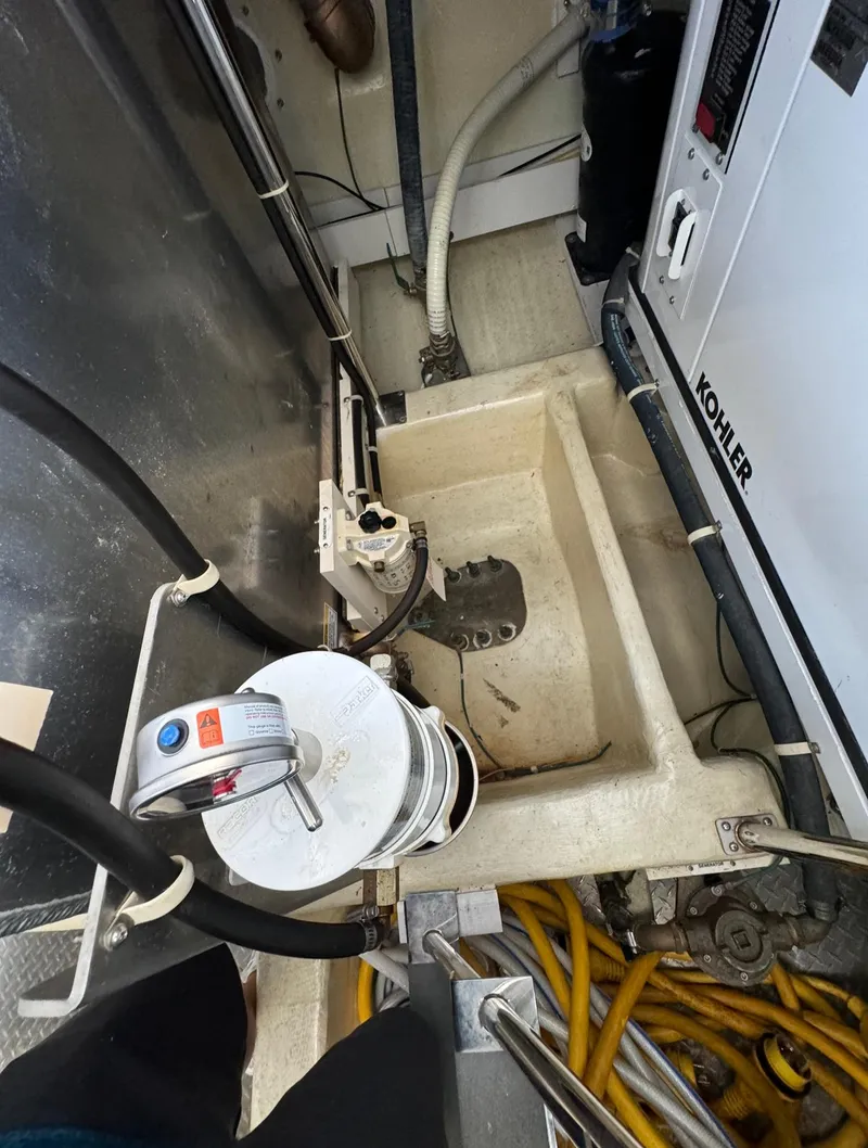 Slide: The Image of Engine room of 2013 Carver 54 Voyager with Kohler generator and hoses. - 49