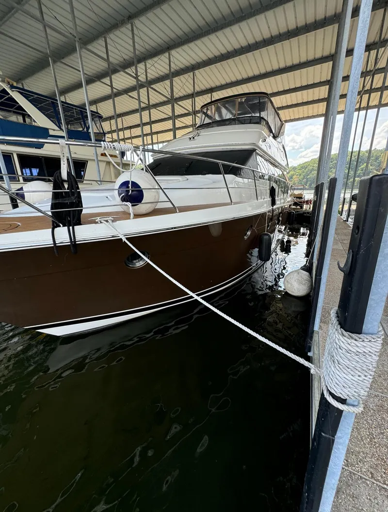 Slide: The Image of 2013 Carver 54 Voyager yacht docked in a covered marina. - 5