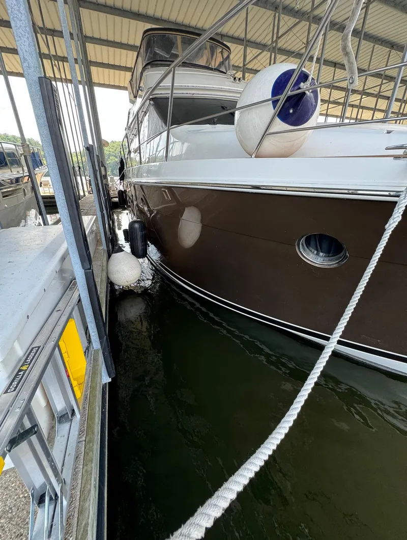 Slide: The Image of 2013 Carver 54 Voyager yacht docked in a covered marina. - 7