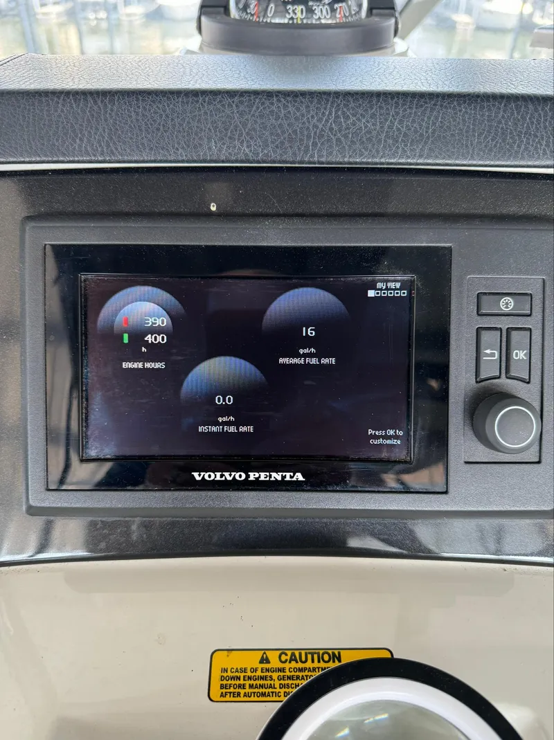 Slide: The Image of Volvo Penta display on 2013 Carver 54 Voyager yacht dashboard, showing engine metrics. - 8