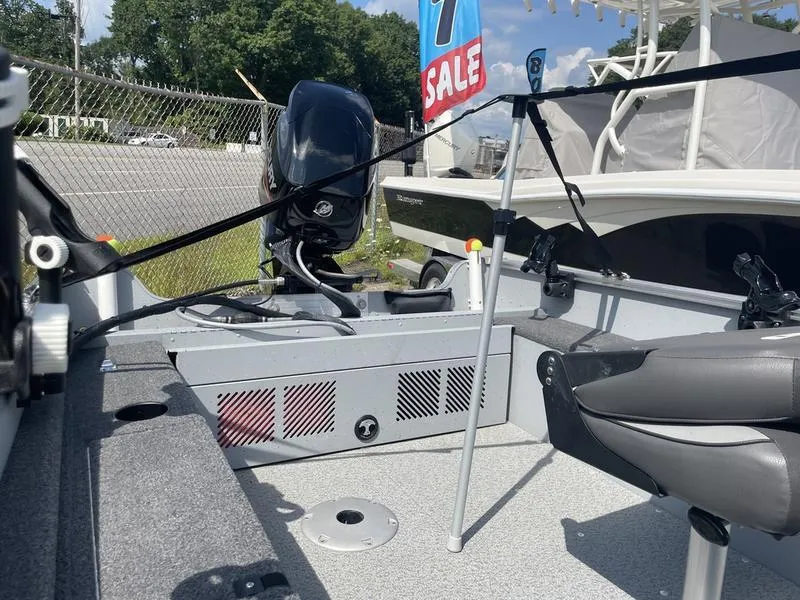 Slide: The Image of 2023 Lund 1600 Fury boat interior with motor, for sale sign visible. - 10