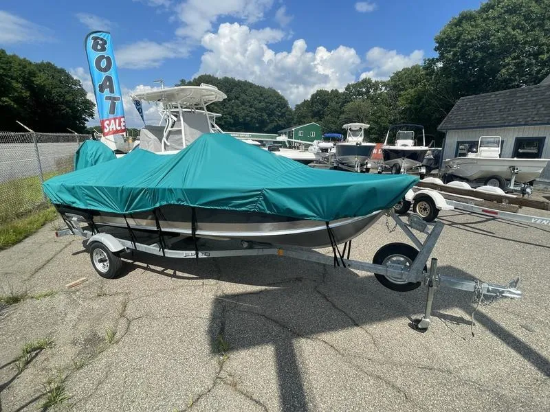 Slide: The Image of 2023 Lund 1600 Fury boat with teal cover on trailer at sale lot. - 3