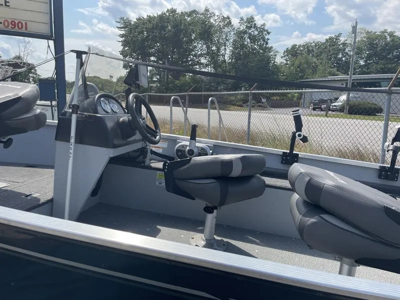 Slide: The Image of 2023 Lund 1600 Fury boat interior with steering wheel and seats. - 6