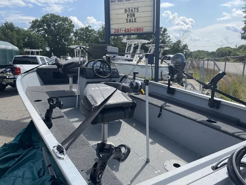 Slide: The Image of 2023 Lund 1600 Fury boat for sale, parked outdoors with fishing equipment. - 8