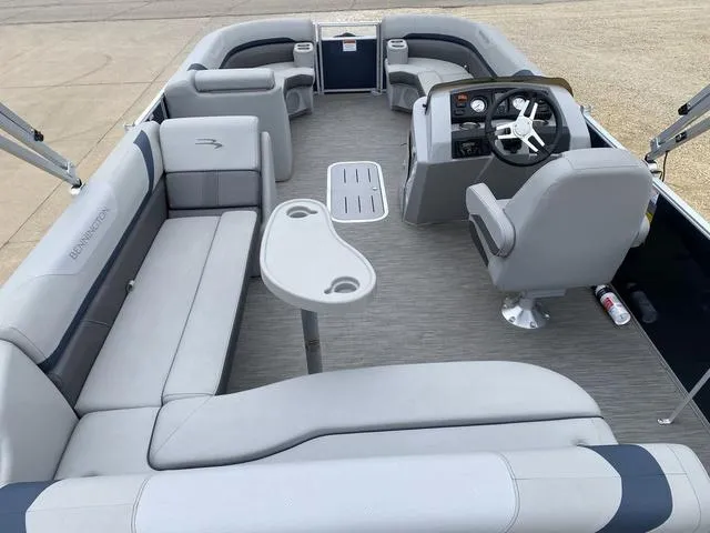 Slide: The Image of 2022 Bennington 22 SSBX pontoon boat interior with gray seating and steering console. - 11