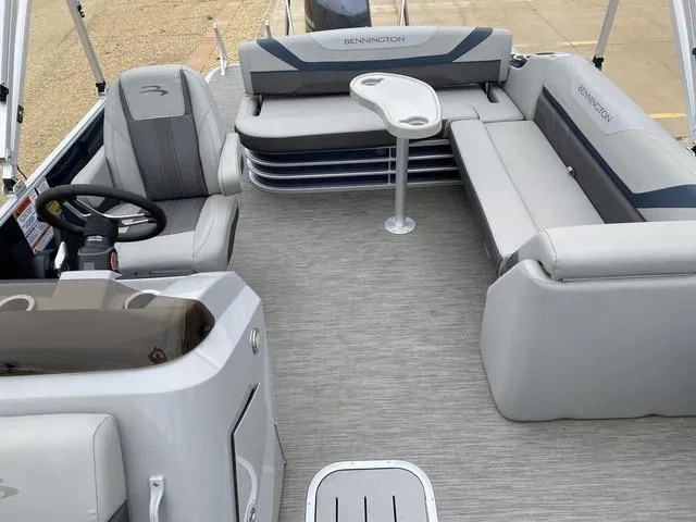 Slide: The Image of 2022 Bennington 22 SSBX boat interior with gray seating and steering wheel. - 13