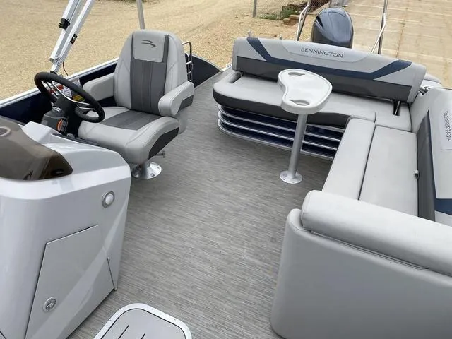 Slide: The Image of 2022 Bennington 22 SSBX pontoon boat interior with gray seating and steering console. - 14