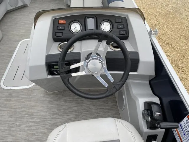 Slide: The Image of 2022 Bennington 22 SSBX boat dashboard with steering wheel and gauges. - 15