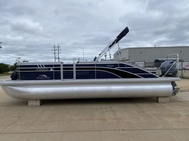 Slide: The Image of 2022 Bennington 22 SSBX pontoon boat on concrete lot, overcast sky. - 2