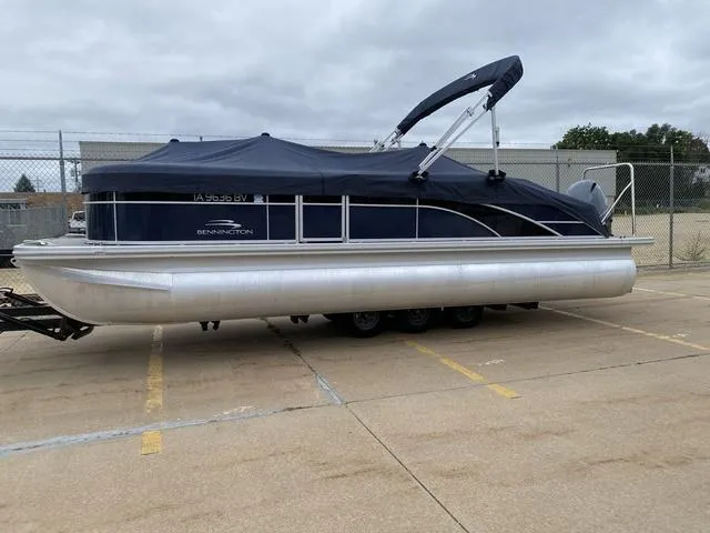 Slide: The Image of 2022 Bennington 22 SSBX pontoon boat with cover in parking lot. - 3