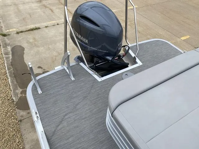 Slide: The Image of 2022 Bennington 22 SSBX pontoon boat with Yamaha outboard motor, gray deck, and seating. - 7
